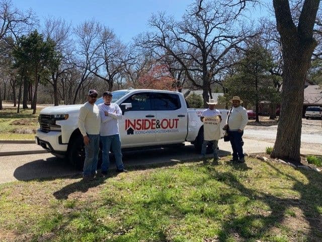 Team standing in front of truck