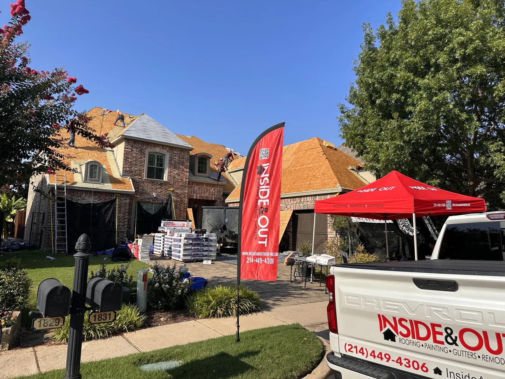 Inside & Out Roofing Sign in front of home